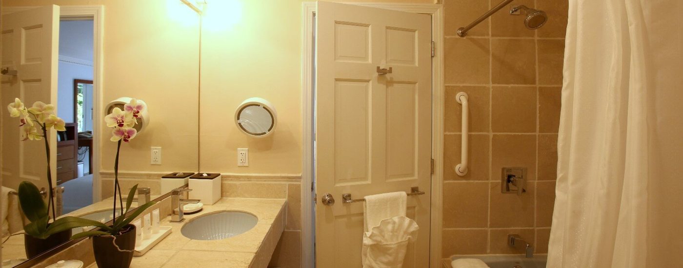 Bathroom with tile vanity and tub with shower